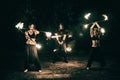 Active girls and boys carries out tricks for fire show at night Royalty Free Stock Photo