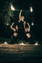 Active girls and boys carries out tricks for fire show at night Royalty Free Stock Photo