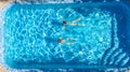 Active girls in swimming pool water aerial drone view from above, children swim, kids have fun on tropical family vacation Royalty Free Stock Photo