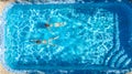 Active girls in swimming pool water aerial drone view from above, children swim, kids have fun on tropical family vacation Royalty Free Stock Photo