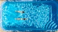 Active girls in swimming pool water aerial drone view from above, children swim, kids have fun on tropical family vacation Royalty Free Stock Photo