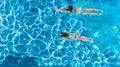 Active girls in swimming pool water aerial drone view from above, children swim, kids have fun on tropical family vacation Royalty Free Stock Photo