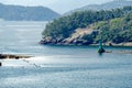 An active green pile beacon on the rock breakwater near shore in Geoje Island, South Korea. Royalty Free Stock Photo