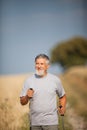 Active handsome senior man nordic walking outdoors Royalty Free Stock Photo