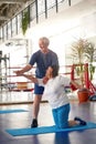 Active happy elderly couple exercising in gym. Royalty Free Stock Photo