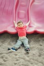 Active happy funny smiling Caucasian boy child sliding on playground schoolyard outdoor on a summer day. Kid having fun. Seasonal Royalty Free Stock Photo