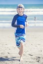 Active, Healthy Boy running on the beach on a sunny day Royalty Free Stock Photo