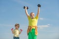 Active healthy life for family. Sports coach and kid building strength with dumbbells. Happy little boy with grandfather Royalty Free Stock Photo