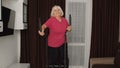 Active healthy senior old mature woman in sportswear using orbitrek, training cardio workout at home Royalty Free Stock Photo
