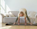 Active healthy senior woman standing in downward facing dog yoga pose while practicing yoga at home Royalty Free Stock Photo