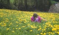 Active healthy woman having rest on beautiful meadow covered with flowers Royalty Free Stock Photo