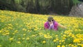 Active healthy woman having rest on beautiful meadow covered with flowers Royalty Free Stock Photo