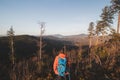 Active hiker enjoys the feeling of reaching the top of the mountain at sunrise. A hiker is enlightened by the morning sun and Royalty Free Stock Photo