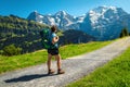 Active hiker woman with backpack, enjoying the view, Murren, Switzerland