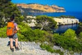 Active hiker woman enjoying the view with sea and cliffs