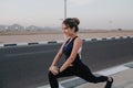 Active joyful sportswoman stretching on road. Tropical country, smiling, cheerful mood, motivation, workout, healthy