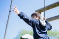 Active kid holding rope chains in playground, Child enjoying outdoors activity in a climbing chains in adventure park on sunny day Royalty Free Stock Photo