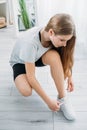 active kids home gym athletic girl tying shoelace Royalty Free Stock Photo
