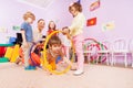Active kindergarten class kids crawl though hoops Royalty Free Stock Photo