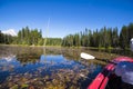 Active leisure on kayak on Trillium Lake with water lilies and s Royalty Free Stock Photo