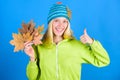 Active leisure and rest autumn season. Woman wear knitted hat hold fallen leaves. Skincare and beauty tips. Skincare