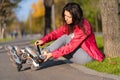 Active leisure. A sportive girl is rollerblading in an autumn park