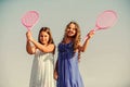 Active life. Children play tennis blue sky background. Sporty kids. Small girls with pink tennis racket. Summer leisure