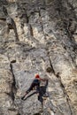 Active life, rock climbing, man rock climber climbing the challenging route on the rocky wall Royalty Free Stock Photo