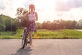 Active life. A young woman with cycling at the sunset in the park. Bicycle and ecology concept Royalty Free Stock Photo