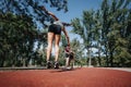 Two sporty girls doing cartwheels in a sunny park, training outdoors and enjoying an active lifestyle together. Royalty Free Stock Photo