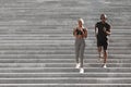 Active Lifestyle. Black Jogger Couple Running Down On Urban Stairs, Training Outdoors Royalty Free Stock Photo