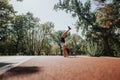 Two women perform cartwheels in a sunny park, enjoying an active lifestyle and having fun outdoors. Royalty Free Stock Photo