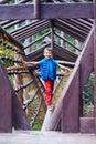 Active little boy at climbing net at playground Royalty Free Stock Photo