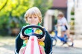Active Little Child Driving Pedal Car In Summer Garden