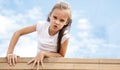 Active little child playing on rock climbing and jumping on school yard playground. Children play and climb outdoors on a sunny Royalty Free Stock Photo