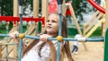 Active little child playing on rock climbing and jumping on school yard playground. Children play and climb outdoors on a sunny Royalty Free Stock Photo