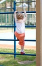 Active little girl climbing on a ladder