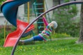 Active little girl hanging on jungle gym outdoors on spring playground Royalty Free Stock Photo