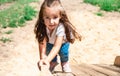 active little girl on playground. playing child on slide