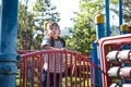 Active little girl running in the outdoor playground in the park. Happy child girl having fun on children playground. Play is Royalty Free Stock Photo