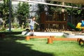 Active little girl walking on balance beam in the outdoor playground in the park. Happy child girl having fun in children Royalty Free Stock Photo