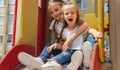 active little girls on playground. playing child on slide