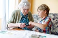 Active little preschool kid boy and grand grandmother playing card game together at home Royalty Free Stock Photo