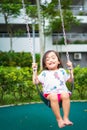 Active little toddler child playing swing at the playground. Happy and fun time Royalty Free Stock Photo