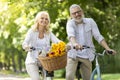 Active Living. Happy Senior Man And Woman Riding Bicycles In Park Together Royalty Free Stock Photo