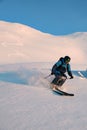 Active male freerider speedly ride down snow-covered slopes on fresh powder snow Royalty Free Stock Photo