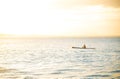 Active Man Canoeing On Calm Ocean at Sunset Time. Copy Space. Water Sport Concept Royalty Free Stock Photo