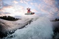 Active man engaged in extreme water sports on the surf style wakeboard. Royalty Free Stock Photo