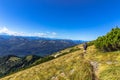 Active man hiking on the peak of Alps, Austria.Backpacker enjoying view of mountain panorama and lake.Hiking on bright sunny Royalty Free Stock Photo