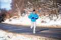 Active man, jogging and running during a sunny winter day. Outdoor working out